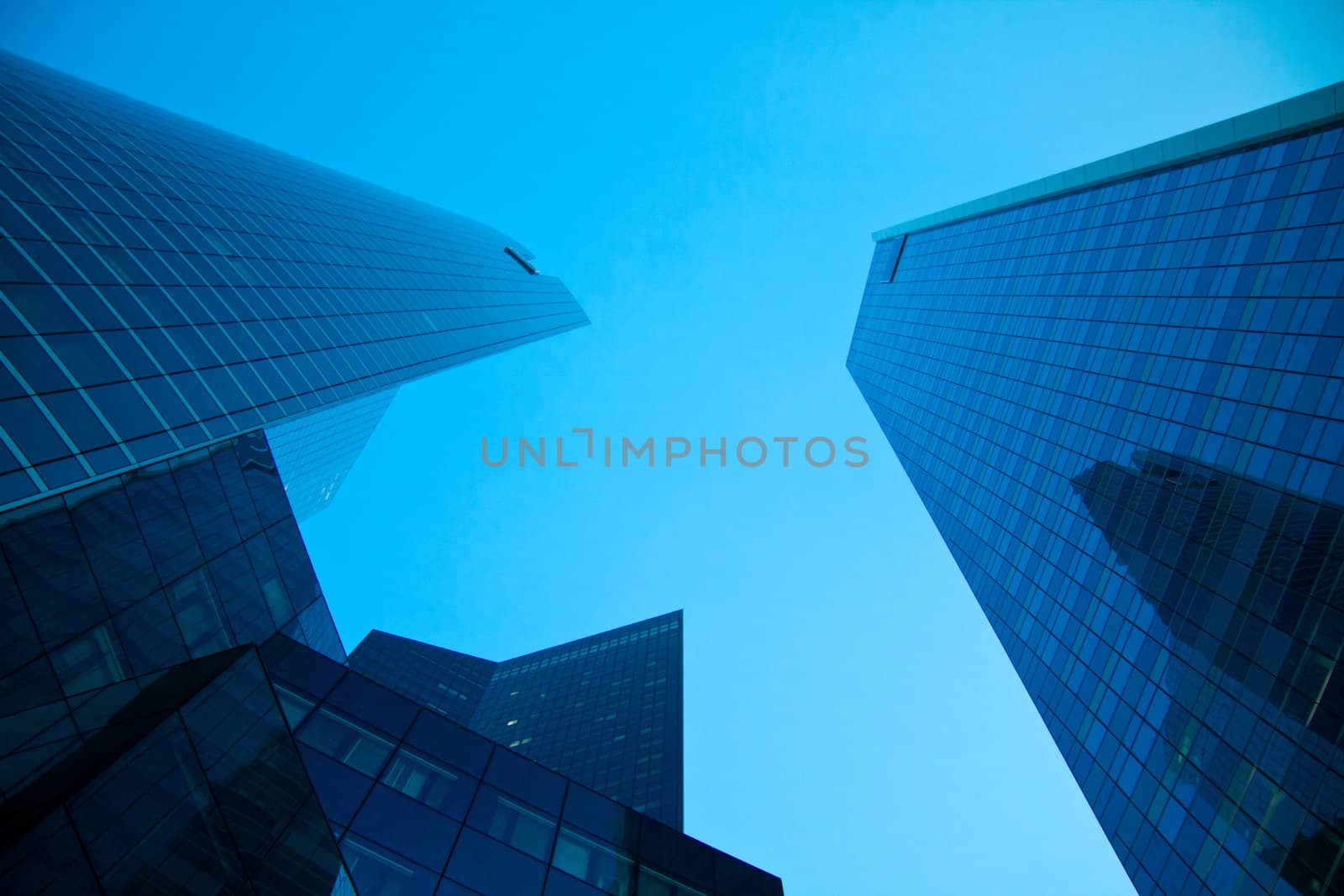 Skyscrapers and blue sky view from below by Lamarinx