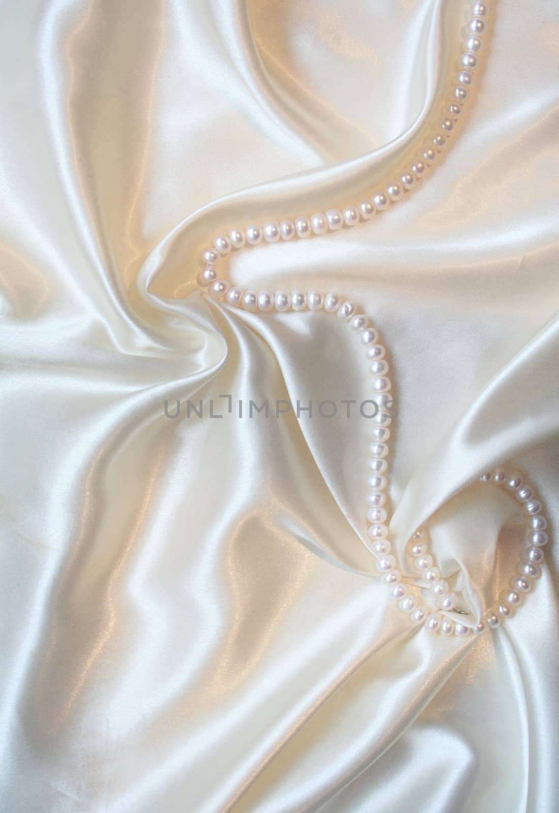 Smooth elegant white silk with pearls can use as wedding background 