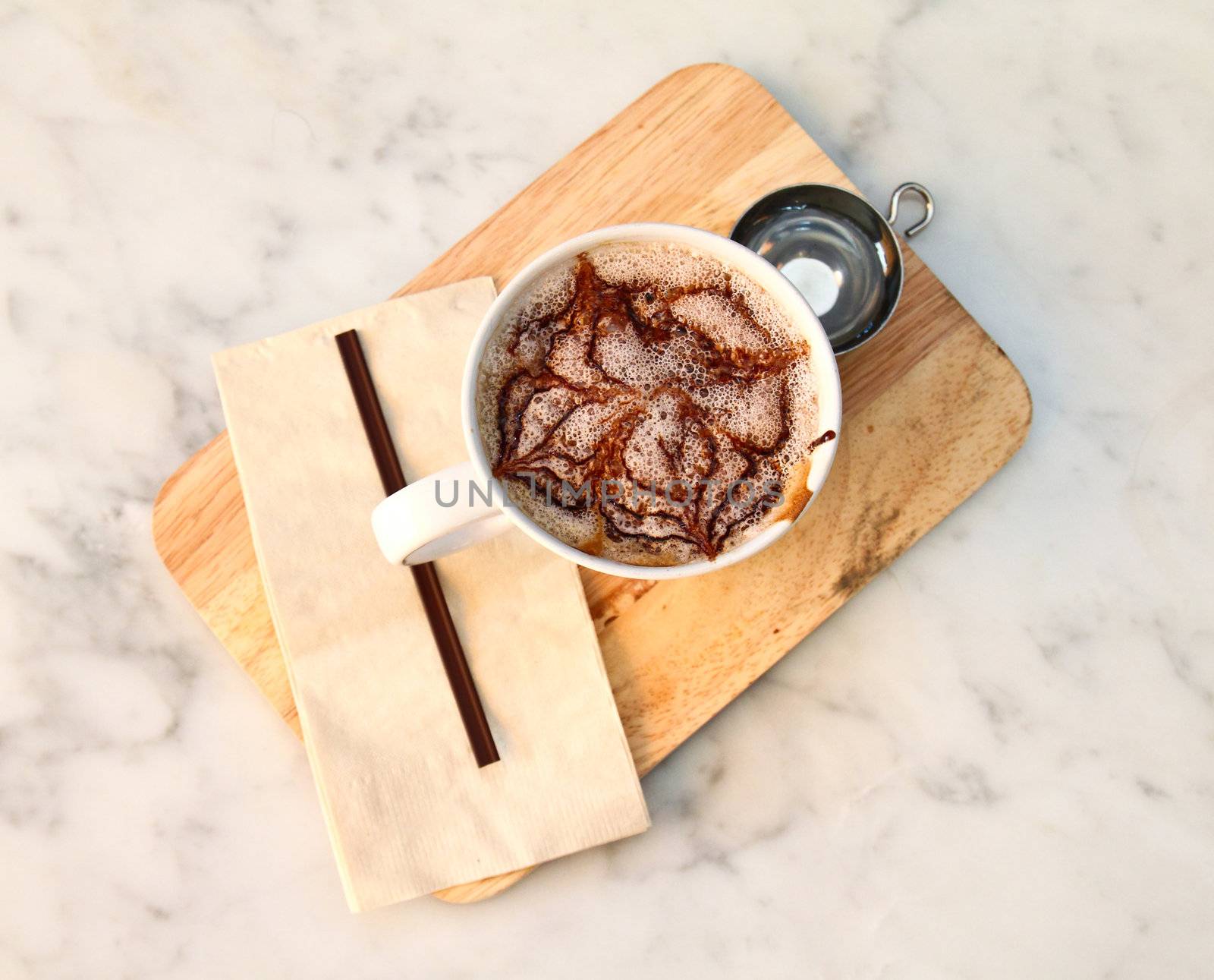 Hot chocolate with syrup on chopping board
