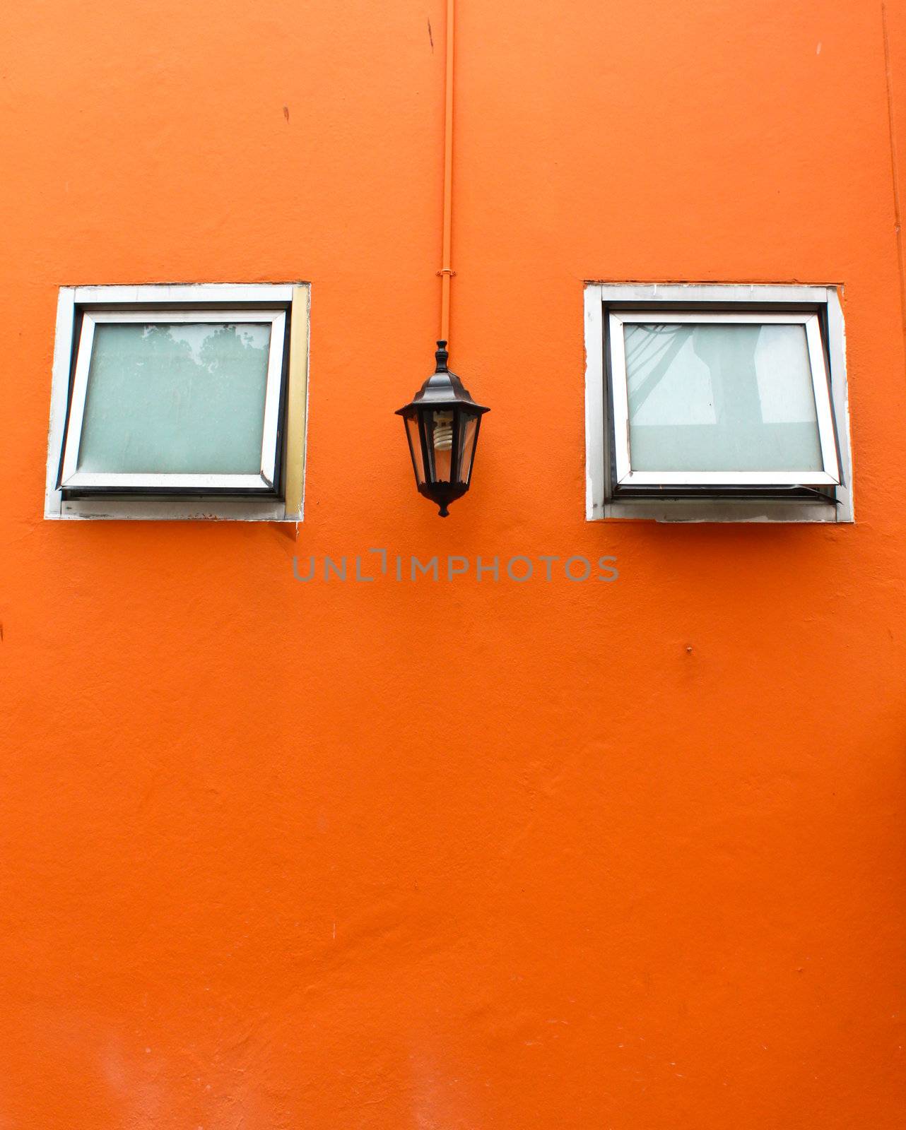 old lamp with windows on orange wall  by nuchylee