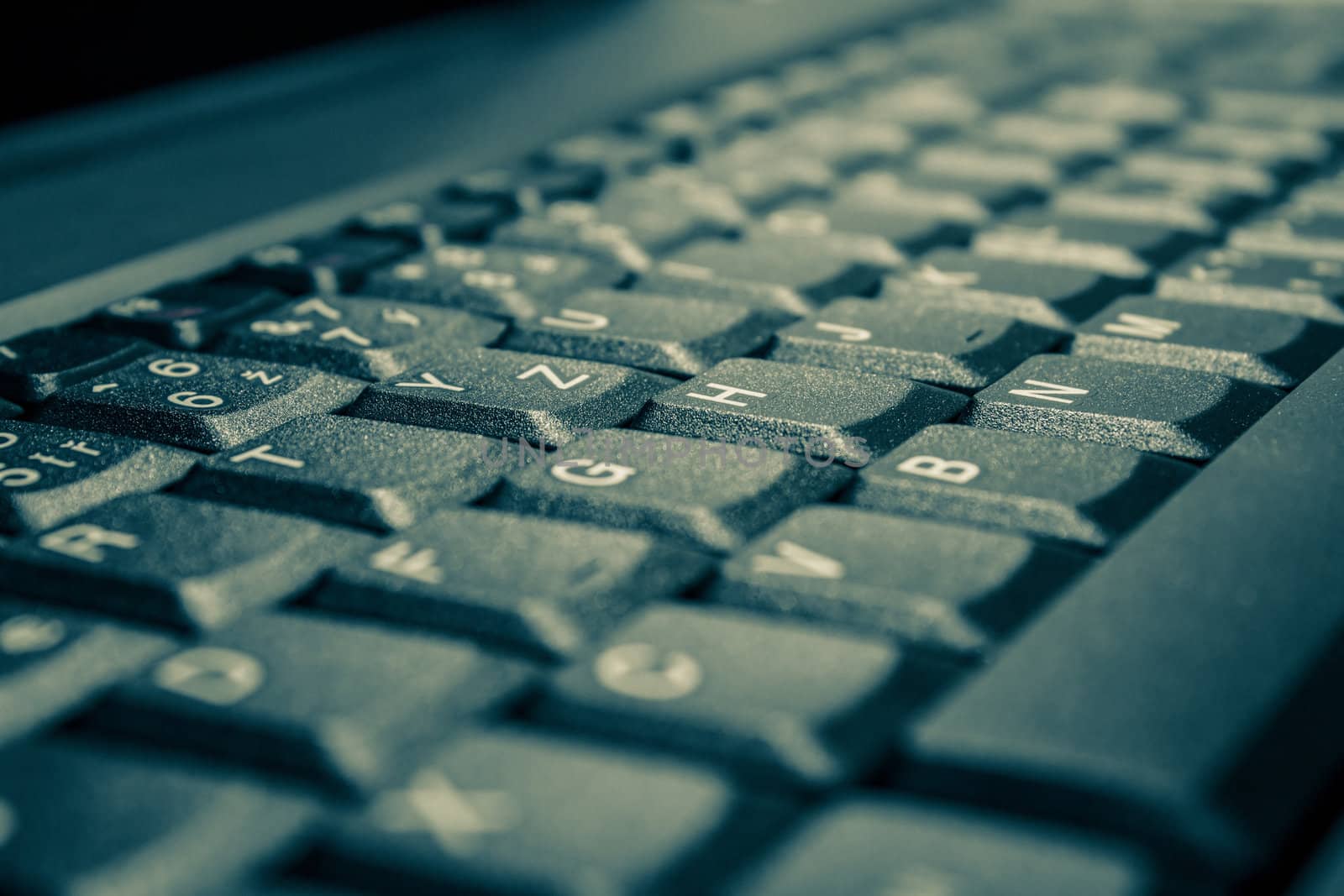 close up of toned laptop keyboard as a background