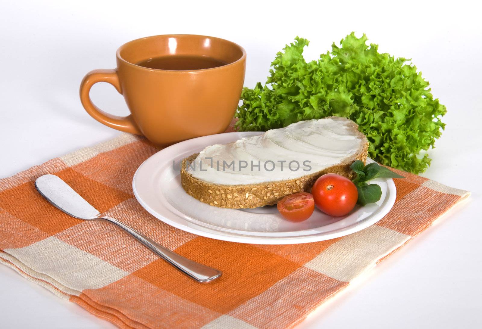 Healthy breakfast consisting of sandwich with butter and vegetables