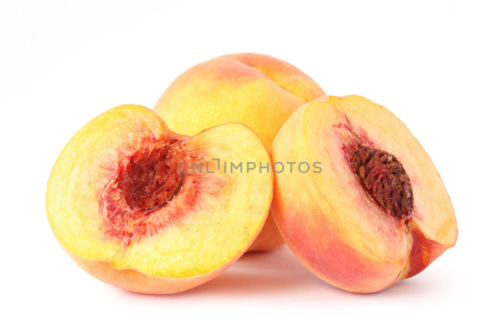 Three peaches isolated on white background