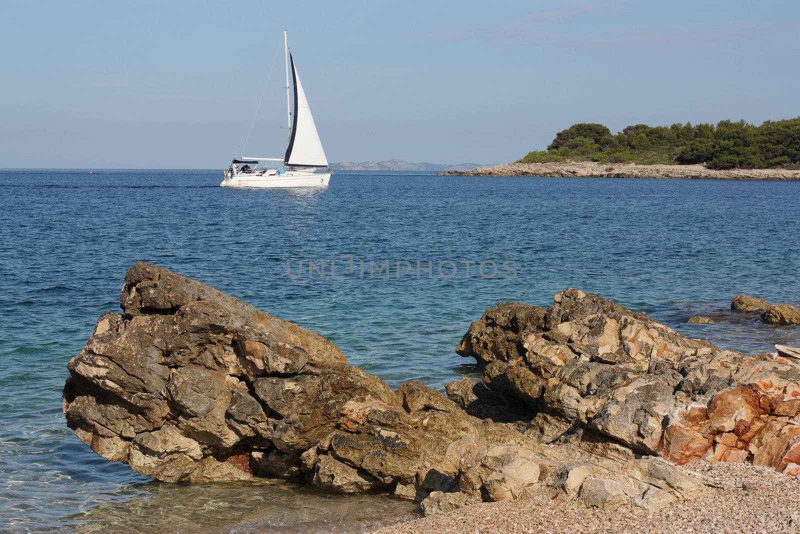 Dalmatian seascape with a yacht sailing
