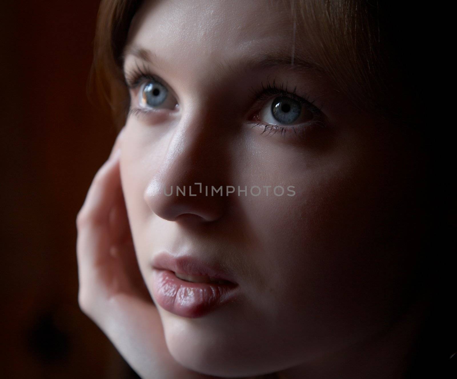 Portrait of the girl in a dark tonality on a dark background