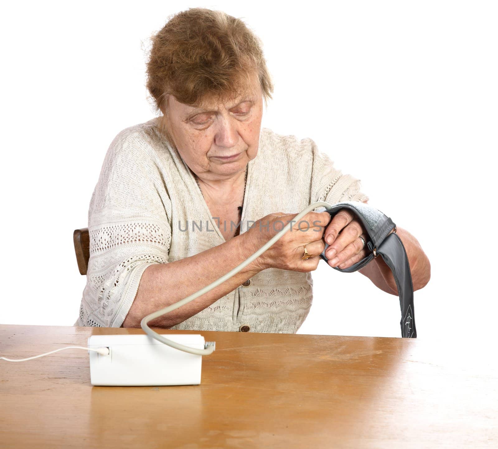 The old woman measures arterial pressure upon a white background