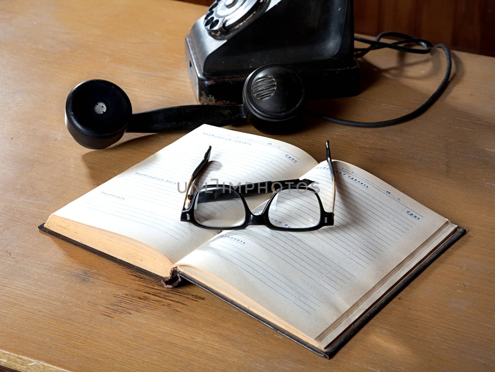 The old daily log with glasses and phone on a table