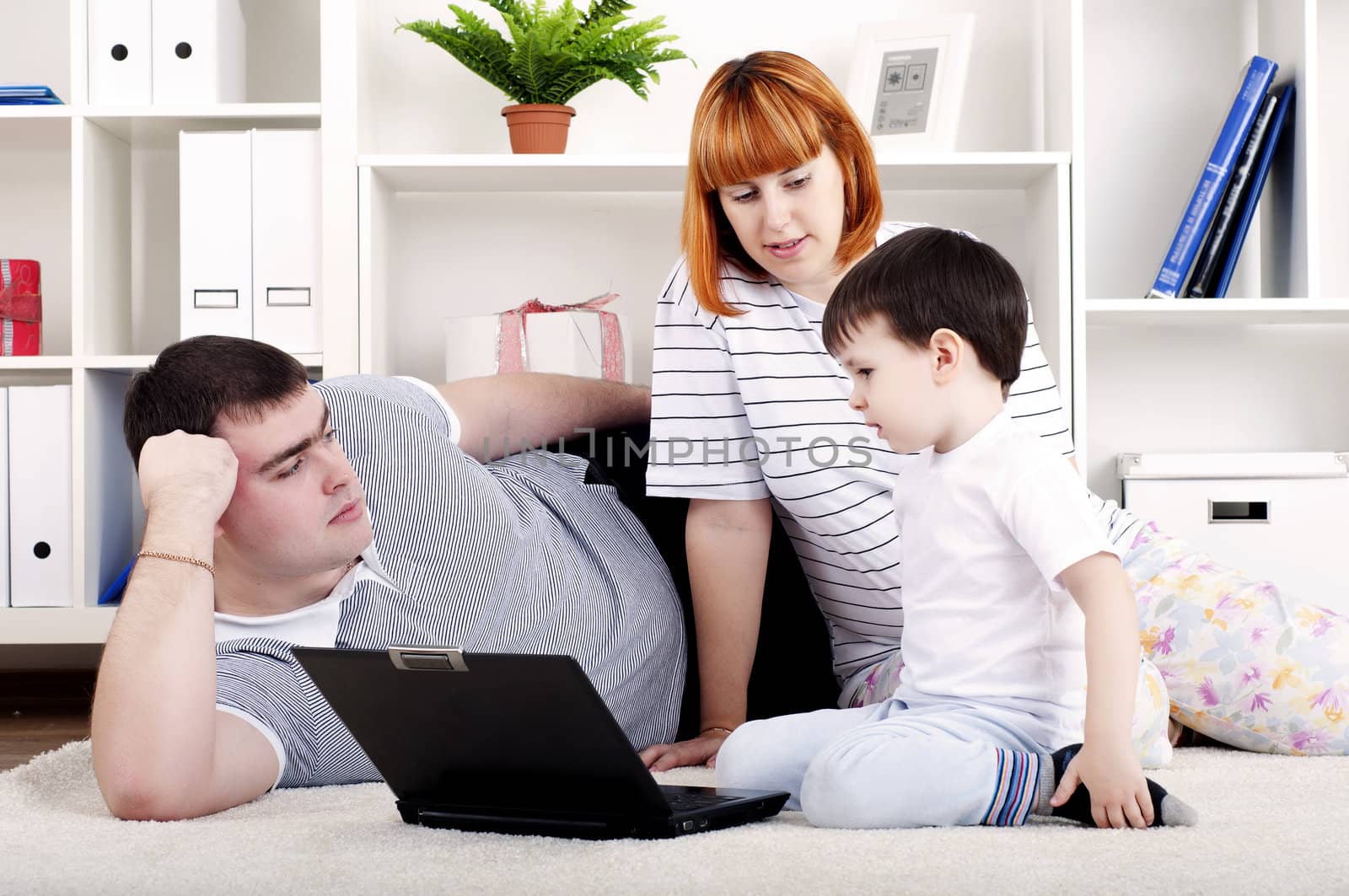 family looking at a laptop by adam121