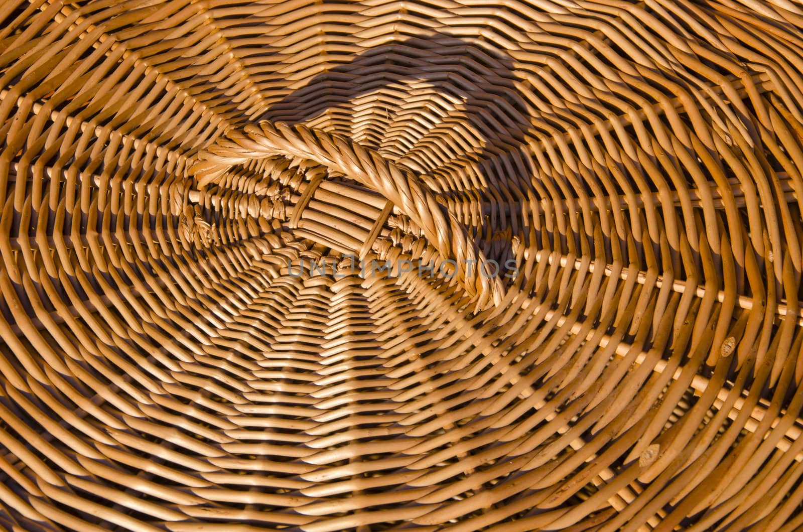 Background of hand-woven basket from reed lid with handle. Rural crafts.