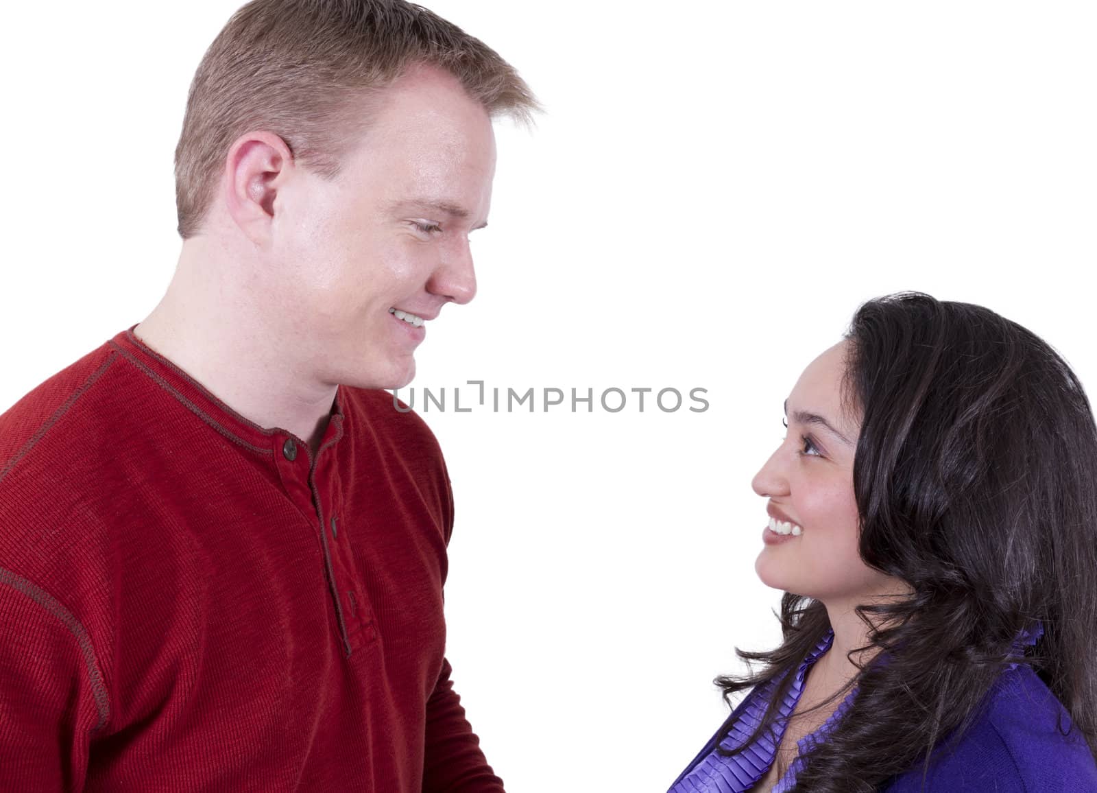 Blonde man and hispanic girl looking at eachother with love. Isolated on white.