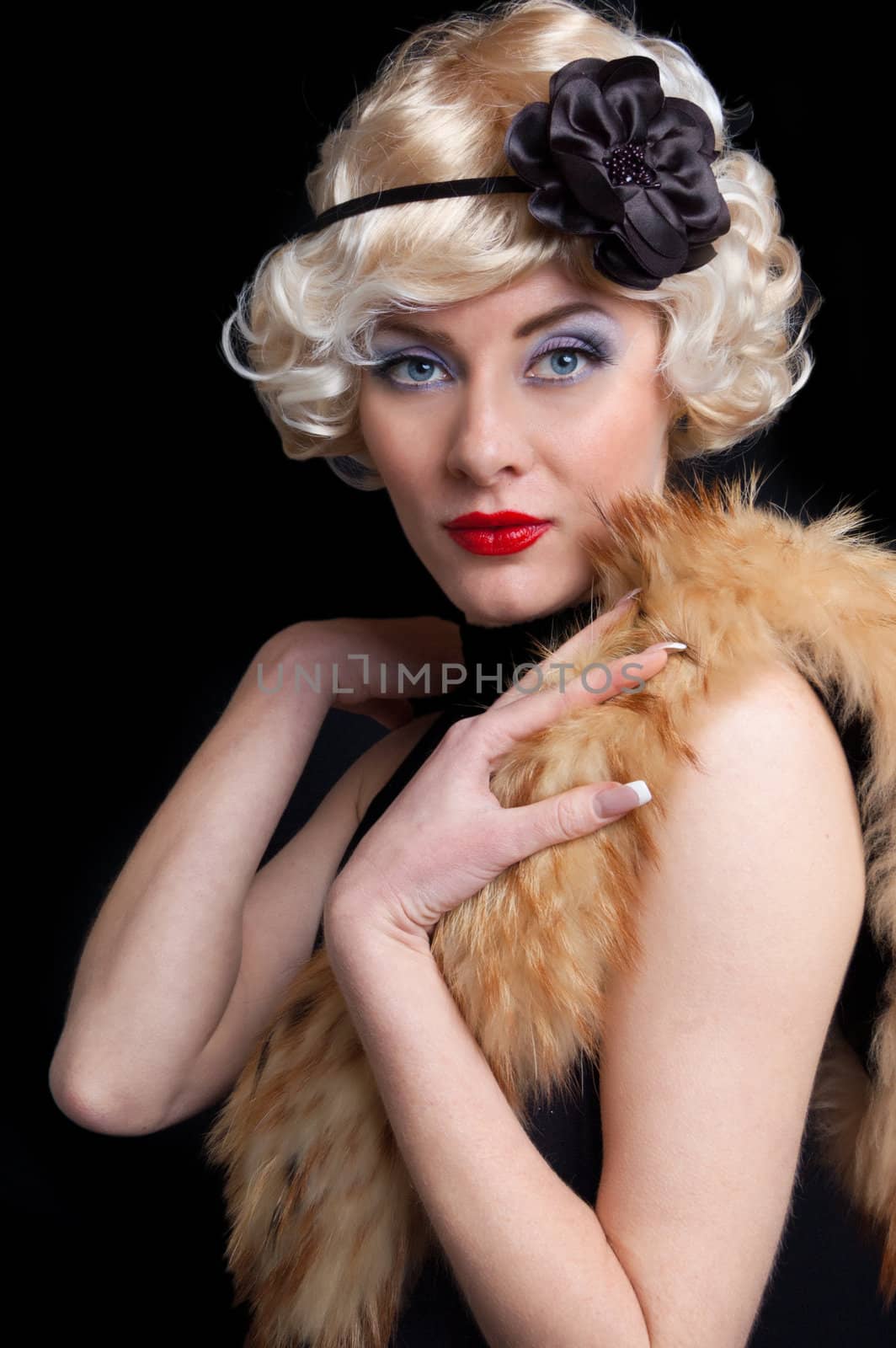 Elegant woman in retrolook with boa on black