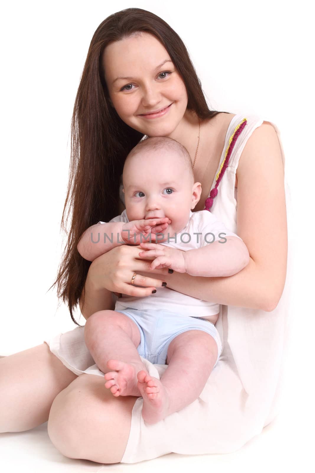 Young mum and the small son, portrait on a white background close up, the kid sits at mum in a lap, a format vertical