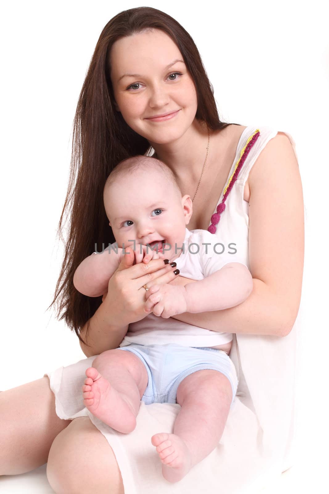 Young mum and the small son, portrait on a white background close up, the kid sits at mum in a lap, a format vertical.