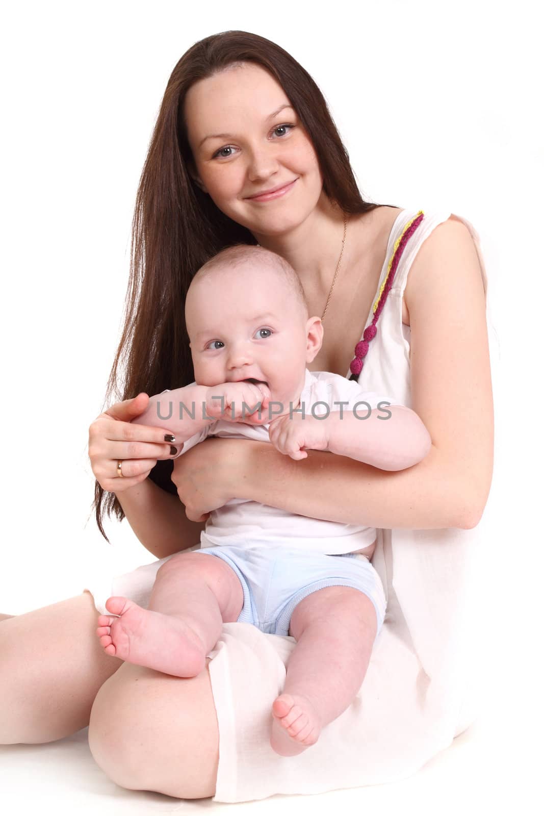 Young mum and the small son, portrait on a white background close up, the kid has put in a mouth a hand, a format vertical.