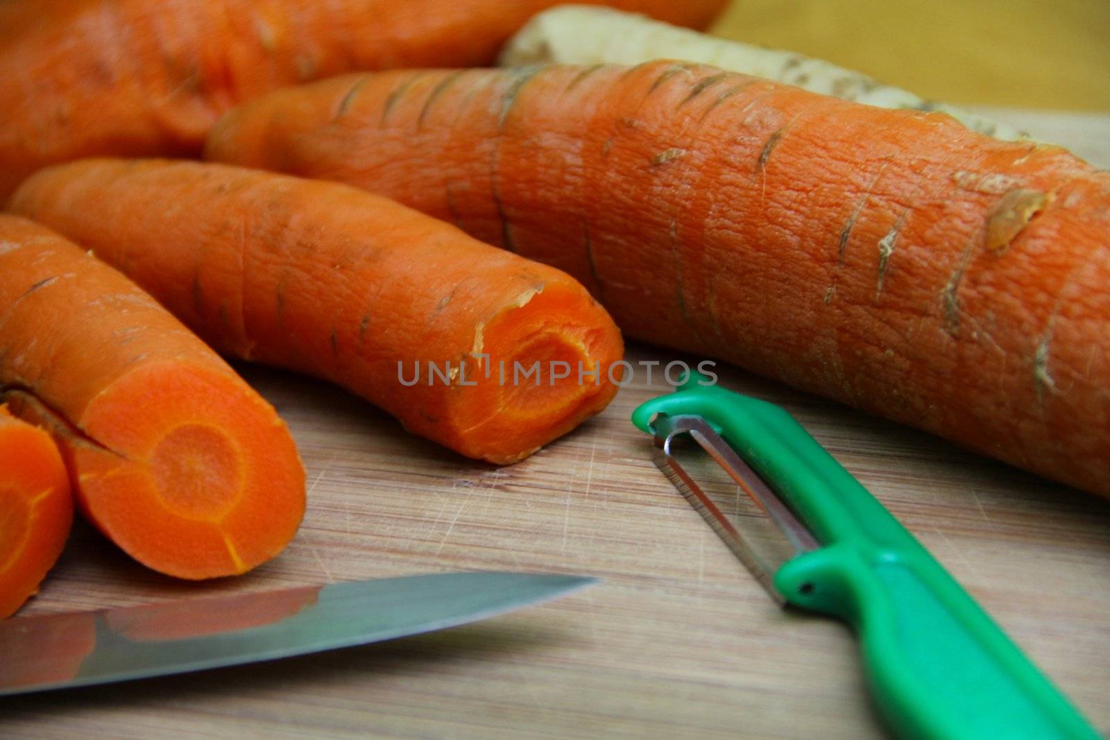 carrots, parsley, cooked vegetables on a board