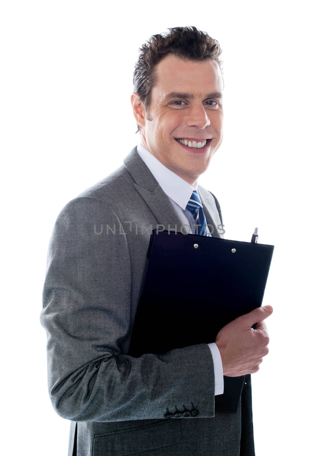 Businessman holding clipboard by stockyimages