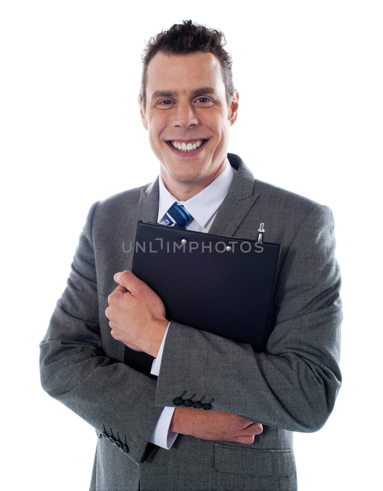 Happy businessman holding a clipboard by stockyimages
