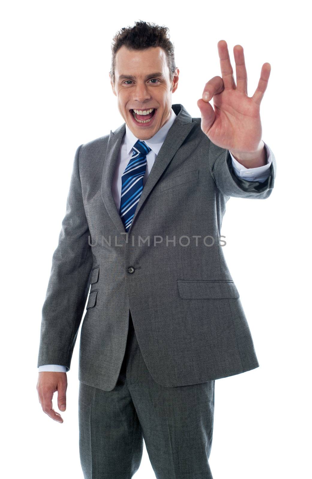 Handsome corporate man gesturing excellent againgt white background