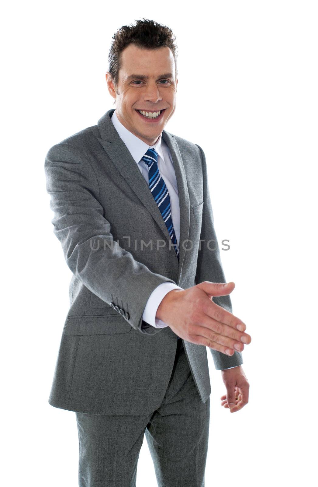 Businessman offering handshake to you, studio shot