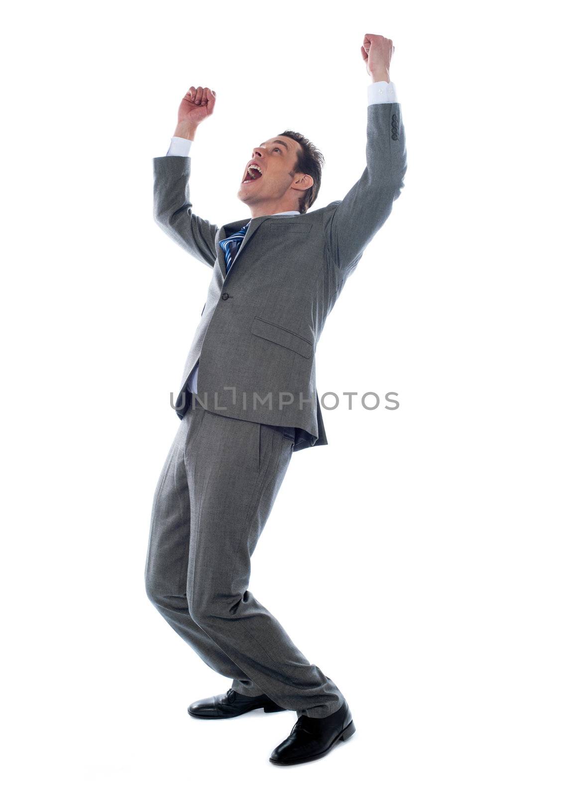 Successful businessman celebrating with arms up isolated over a white background