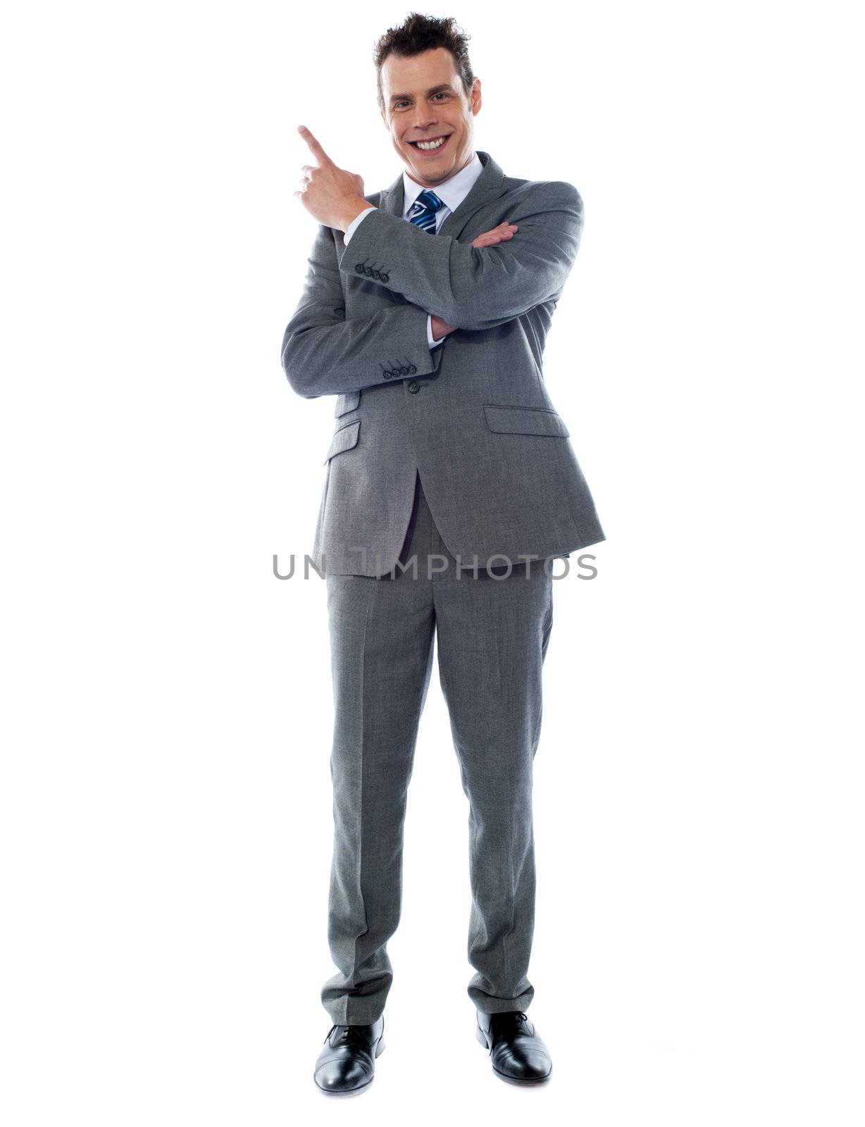 Businessman in suit pointing at copyspace by stockyimages