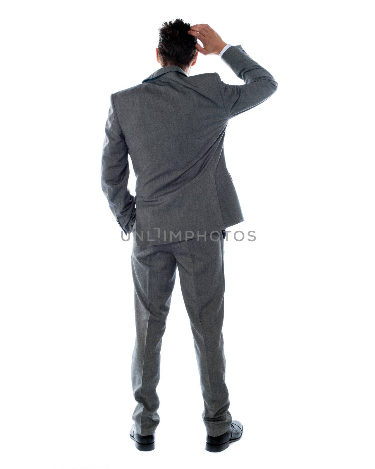 Back-pose of a corporate person thinking. Isolated over white background