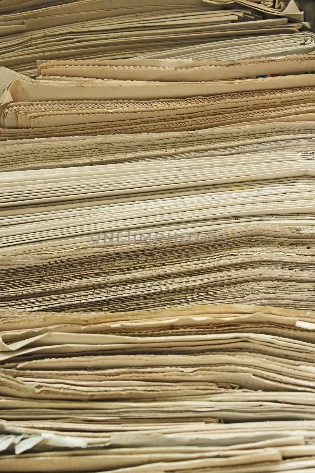 Stack of the old yellowed newspapers close up