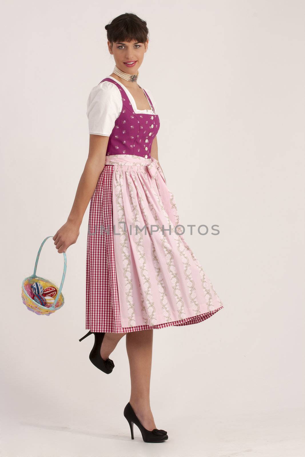 Young woman in Bavarian dress with an Easter basket