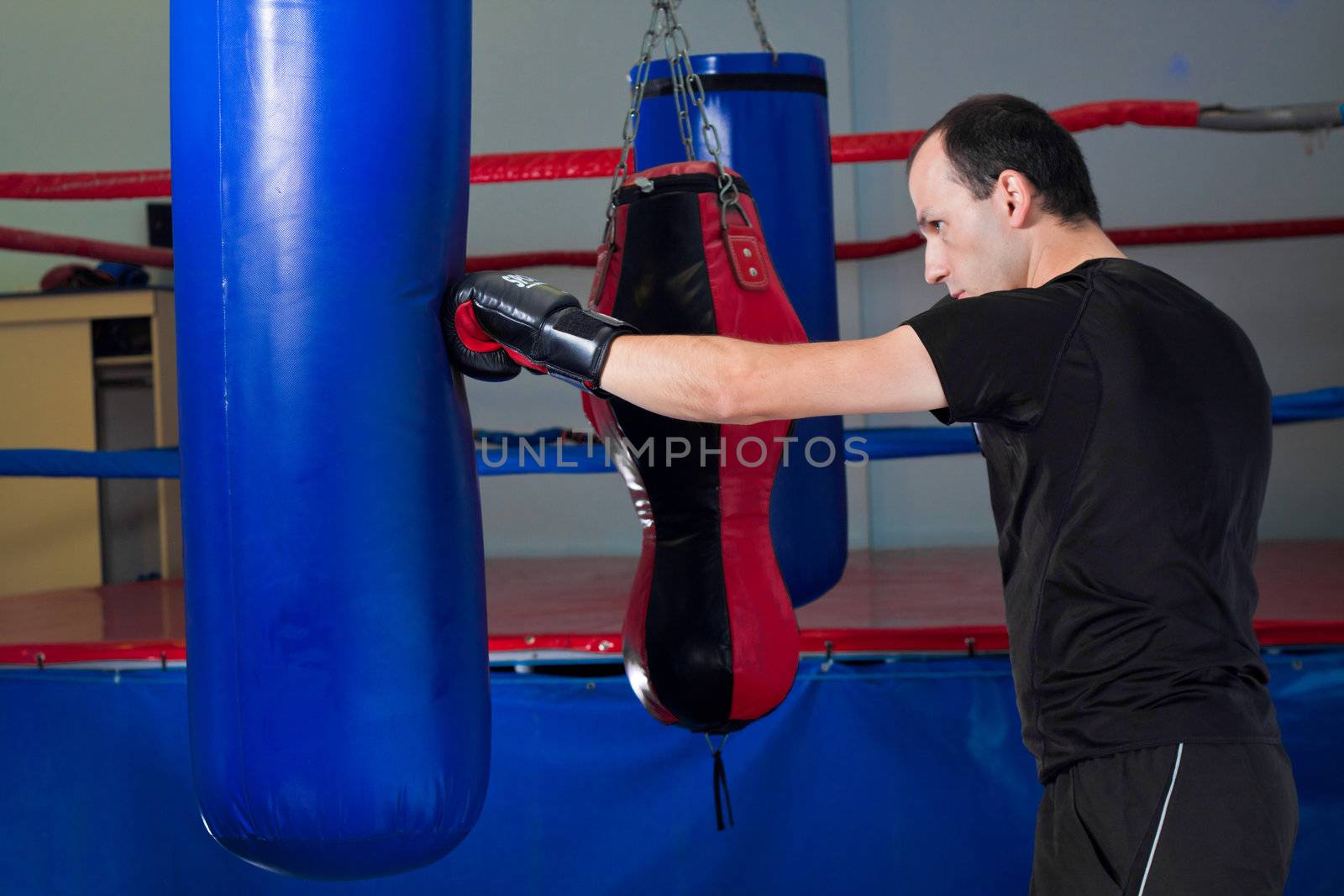 Boxer punching a sand bag with back hand by Lamarinx