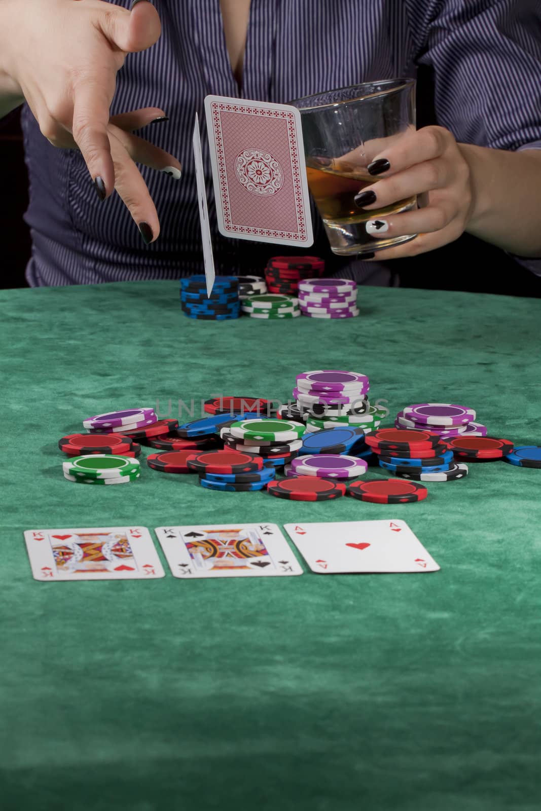 Woman dropping her cards in a poker game.