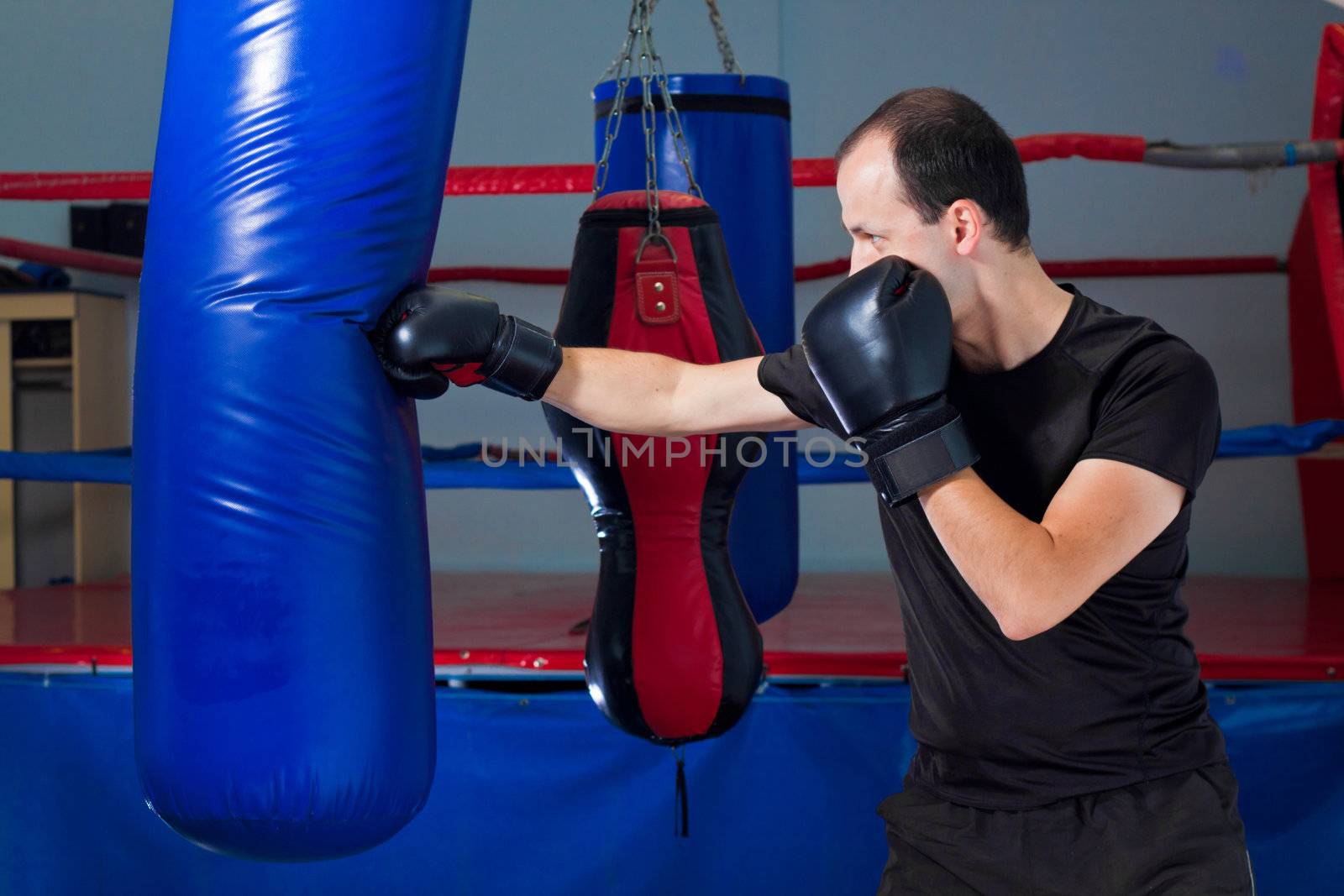 Boxer punching a sand bag with front hand