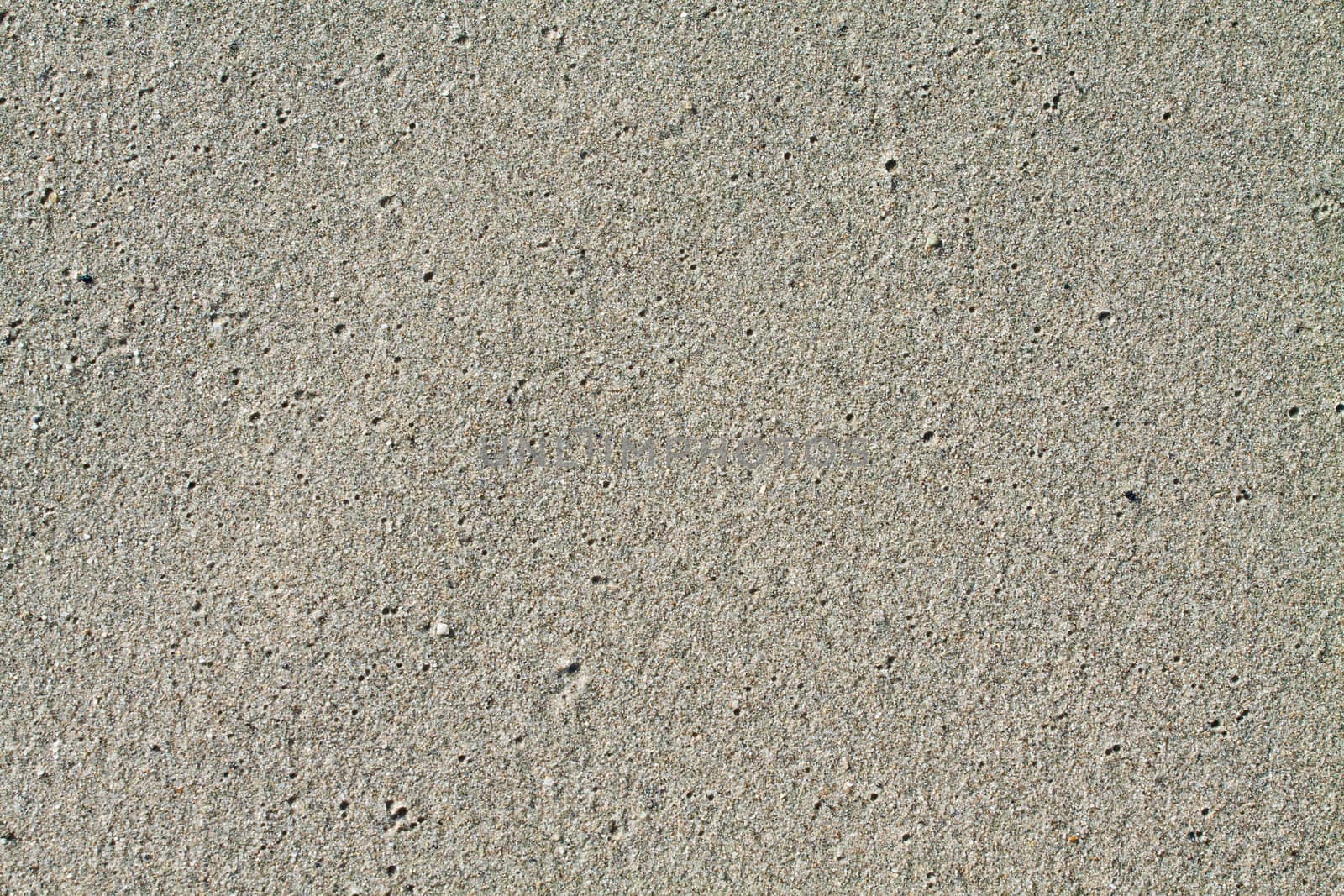 Close up of wet sand ideal for backgrounds and compositions.