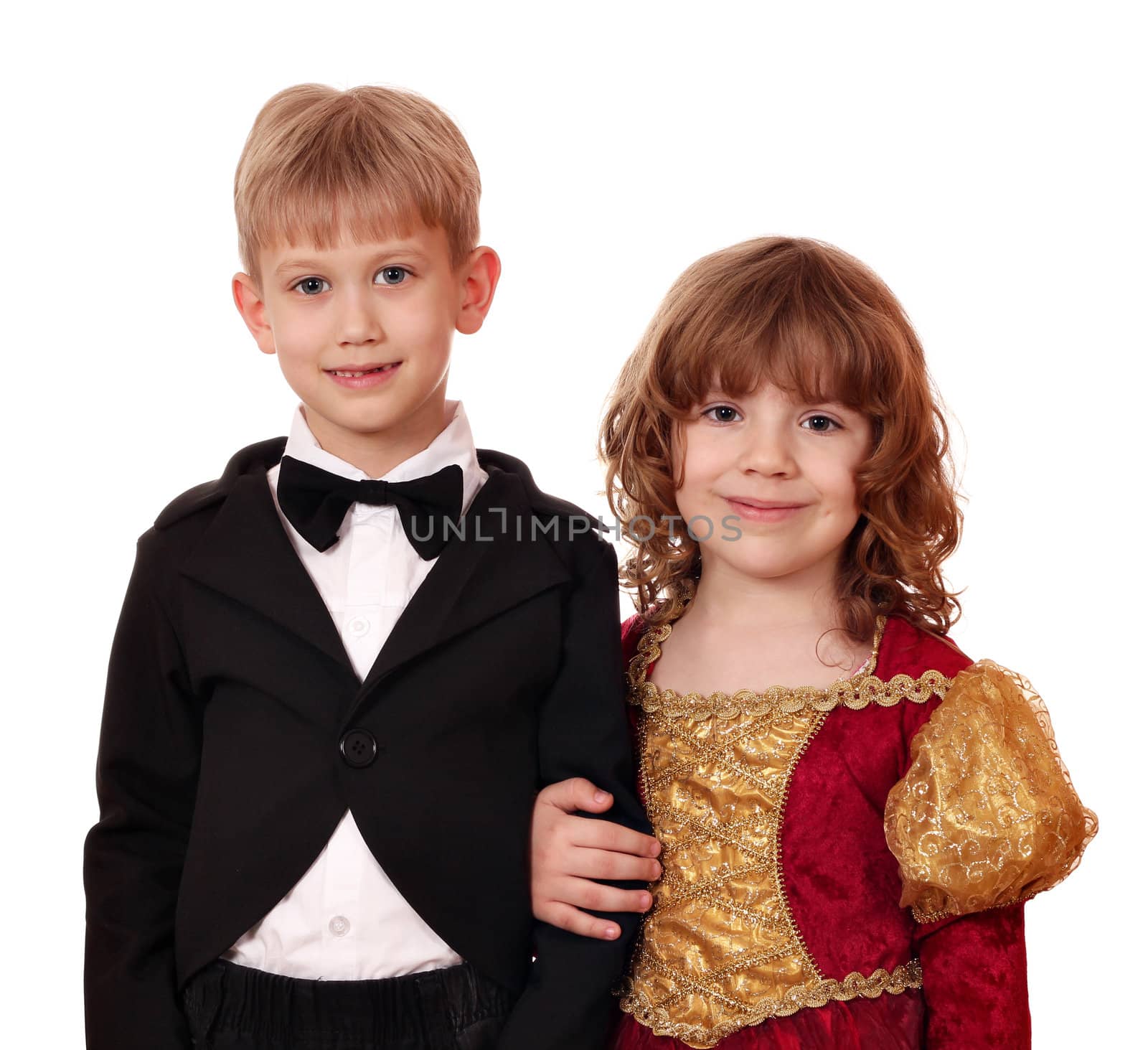boy in tuxedo and little girl in golden dress posing by goce