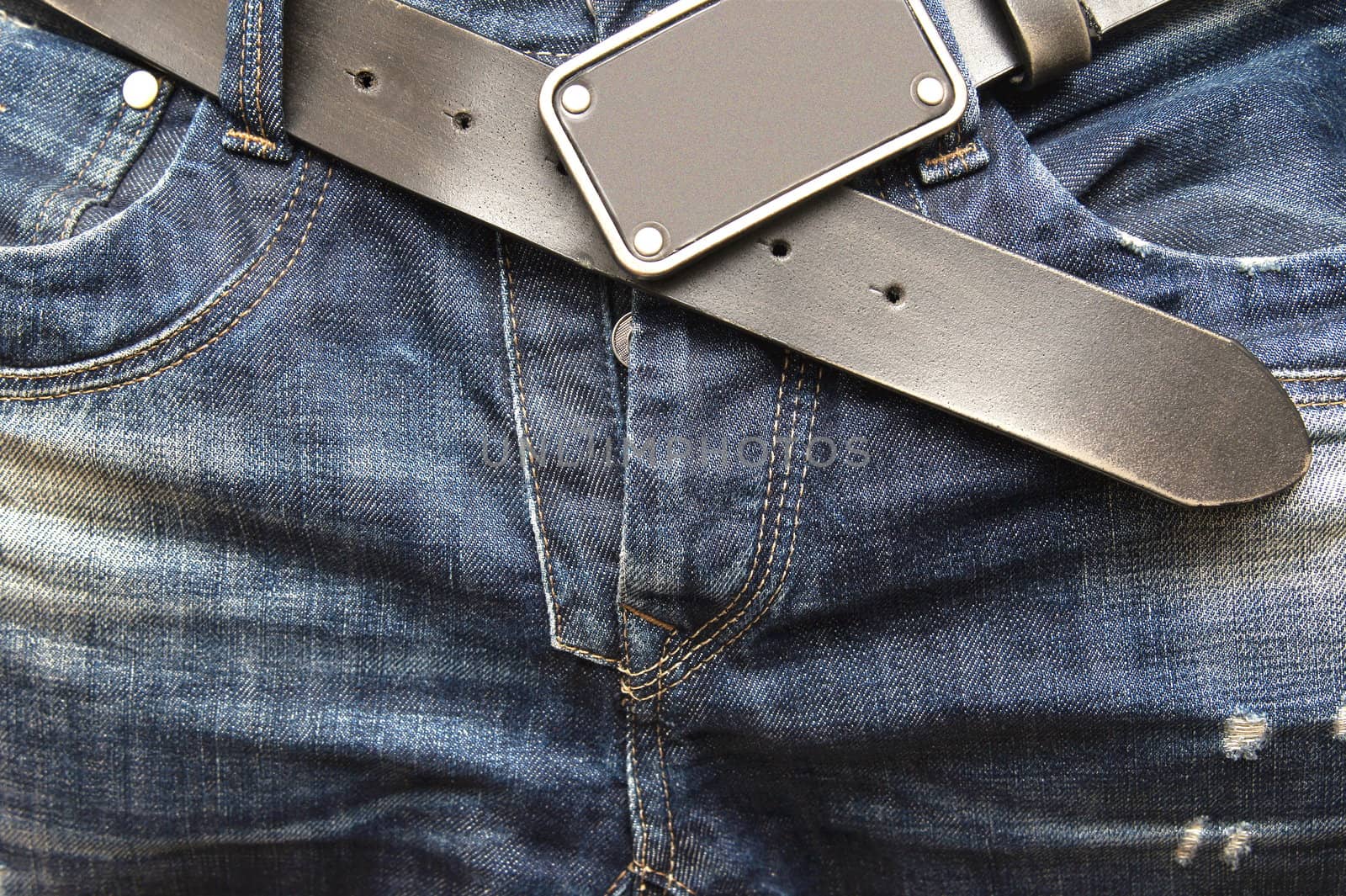 Detail of jeans pocket with belt