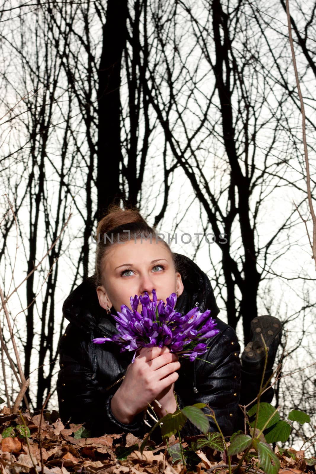 beautiful girl with snowdrops in a forest