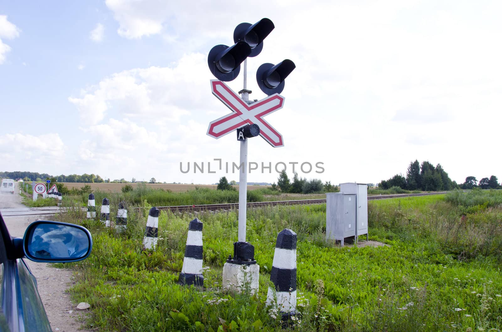 Car stand railway crossing road traffic-light by sauletas