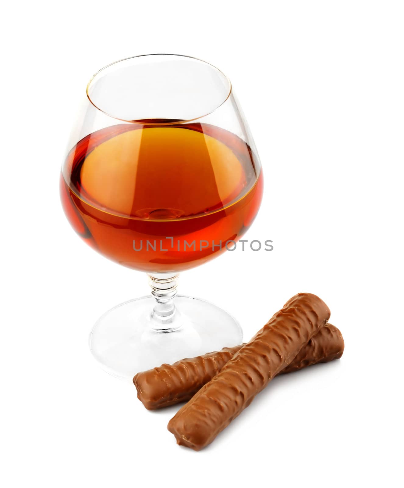 Glass with cognac and chocolate isolated on white by alphacell