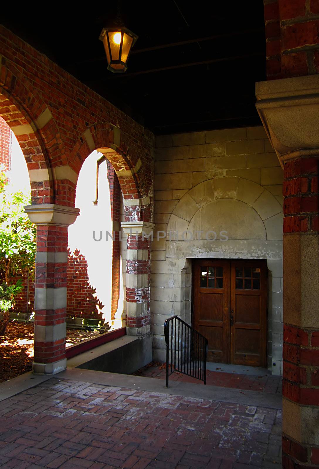 A photograph of an arched walkway of a church detailing its architectural design.