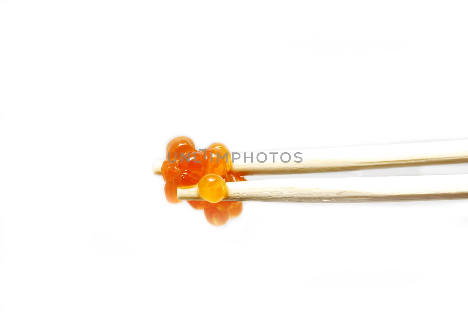 eggs on the chopsticks on a white background