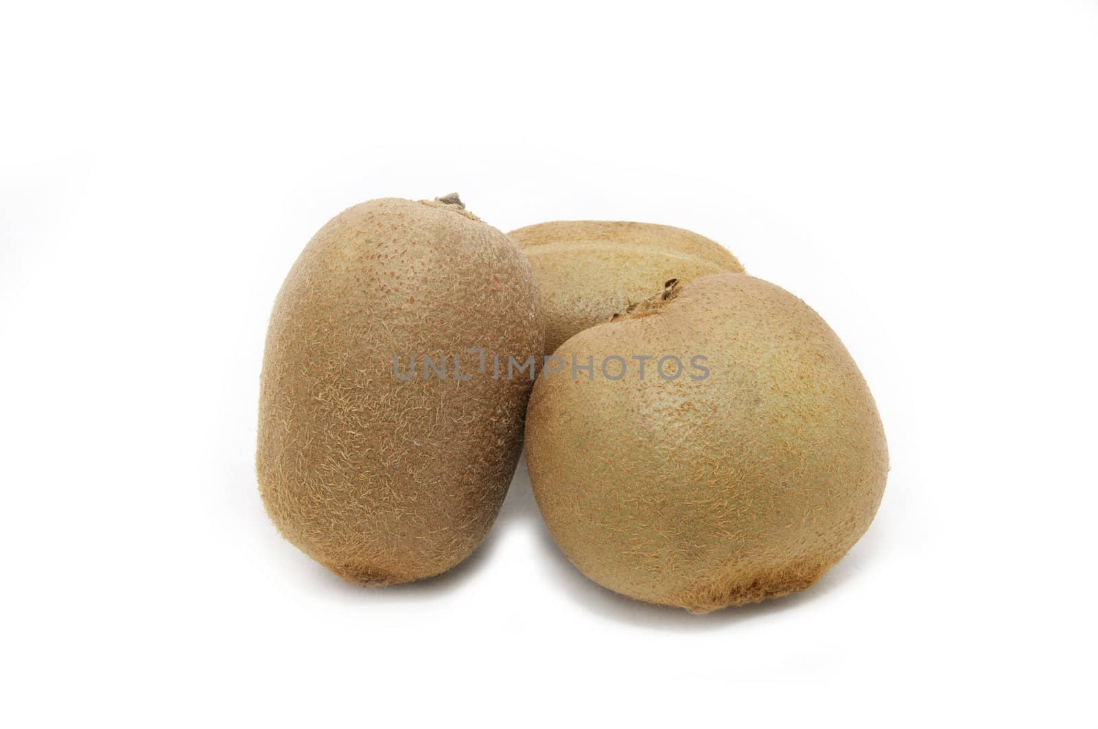 three kiwi fruit on white background close-up