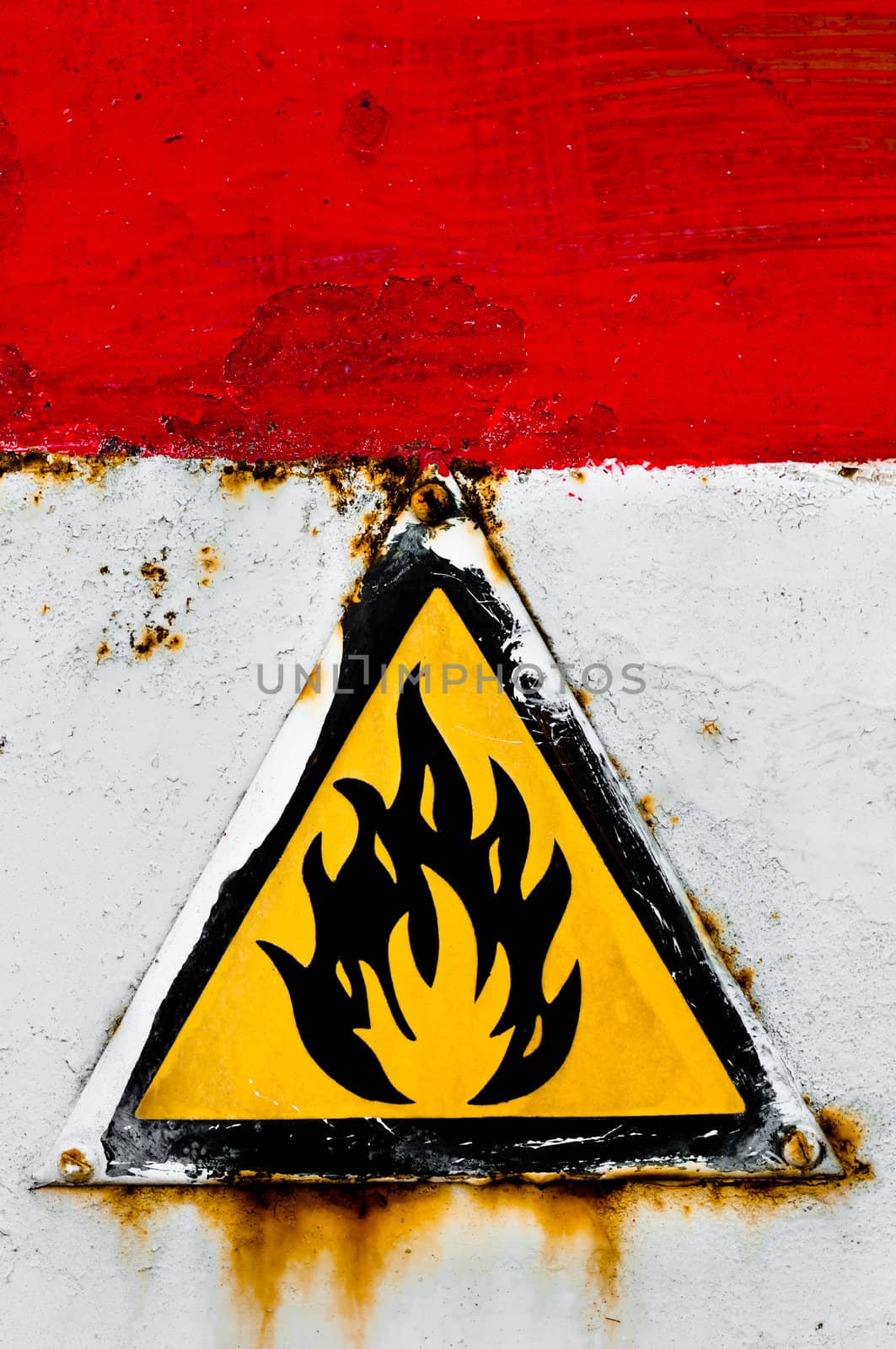 Beware of fire sign on rusty metal