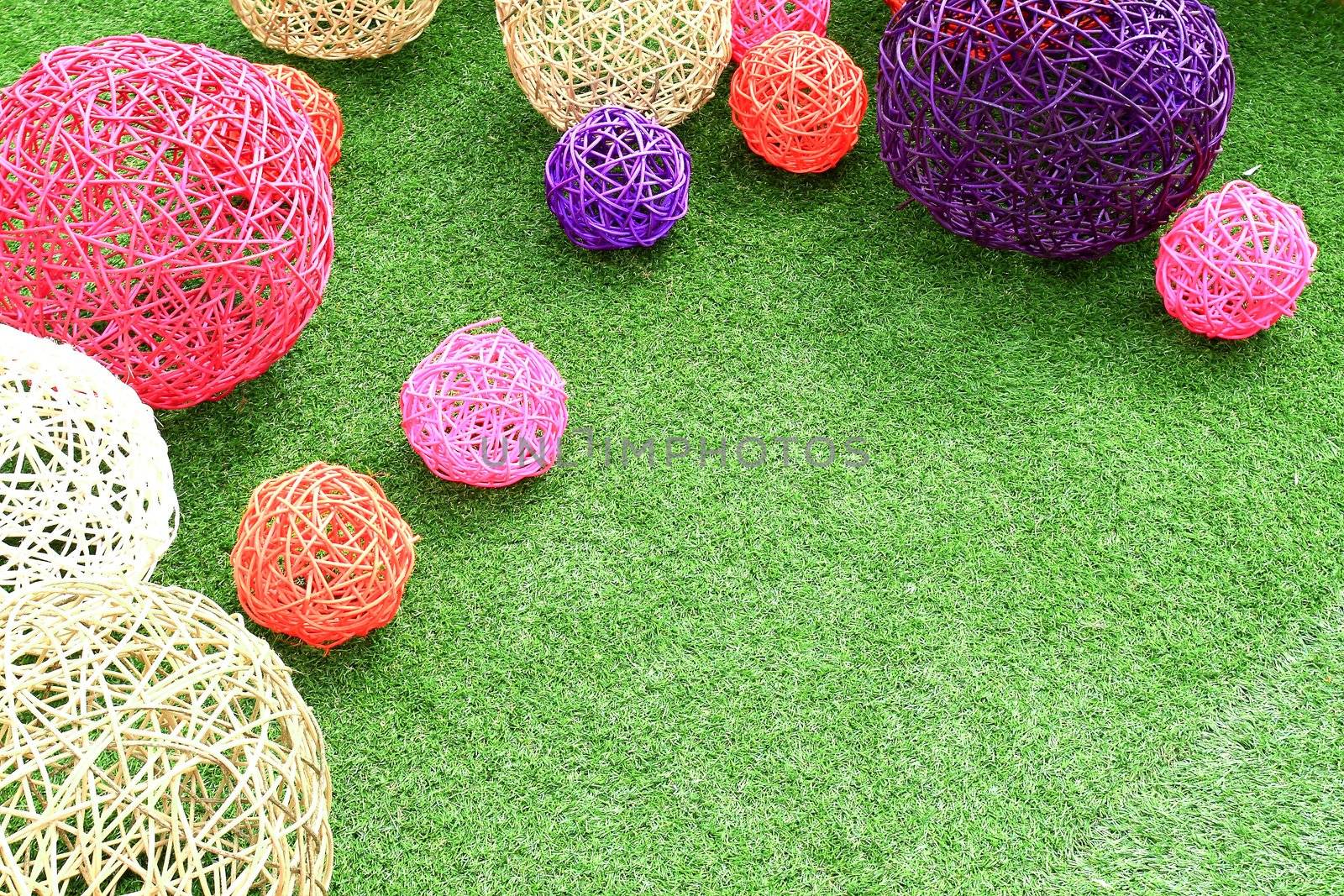 color rattan ball on green grass.
 by rufous