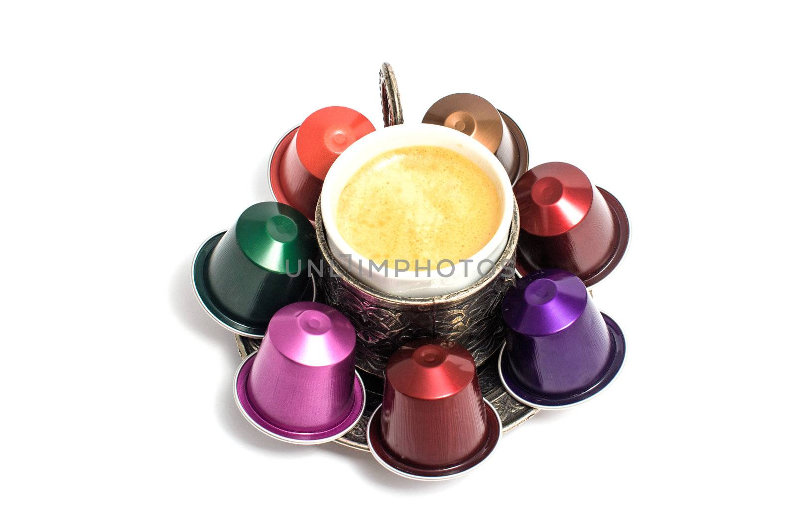 delicious coffee capsules around coffee cup