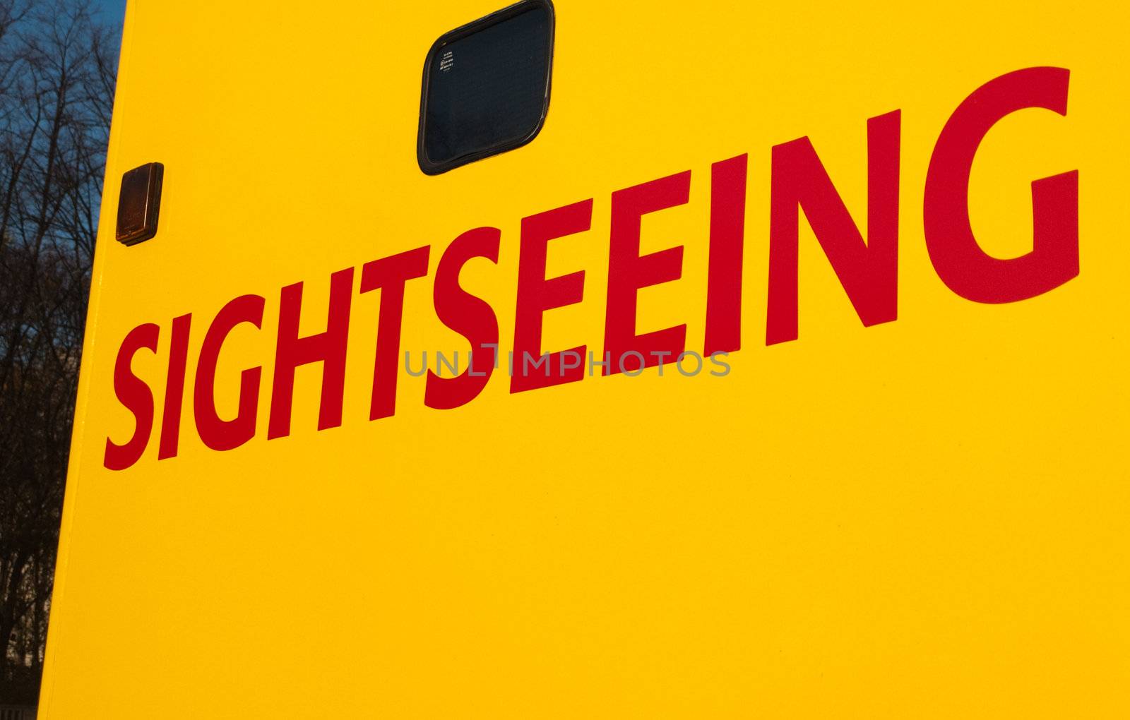 Sightseeing writing on Yellow Tourist Tour Bus in Red Text