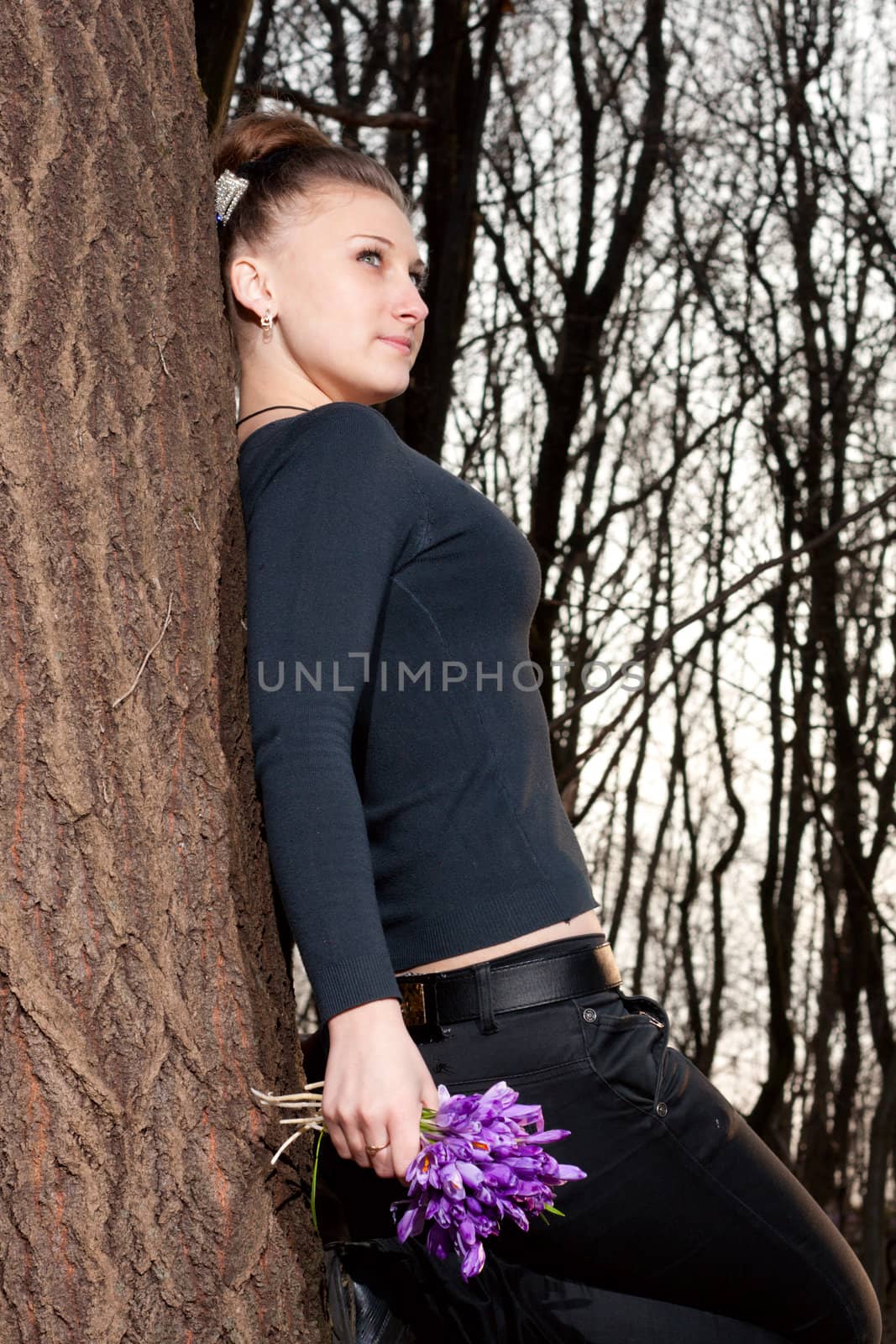 beautiful girl with snowdrops in a forest