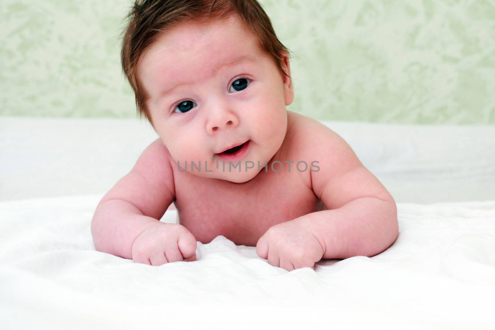 portrait of a close-up, infant lying on the bed