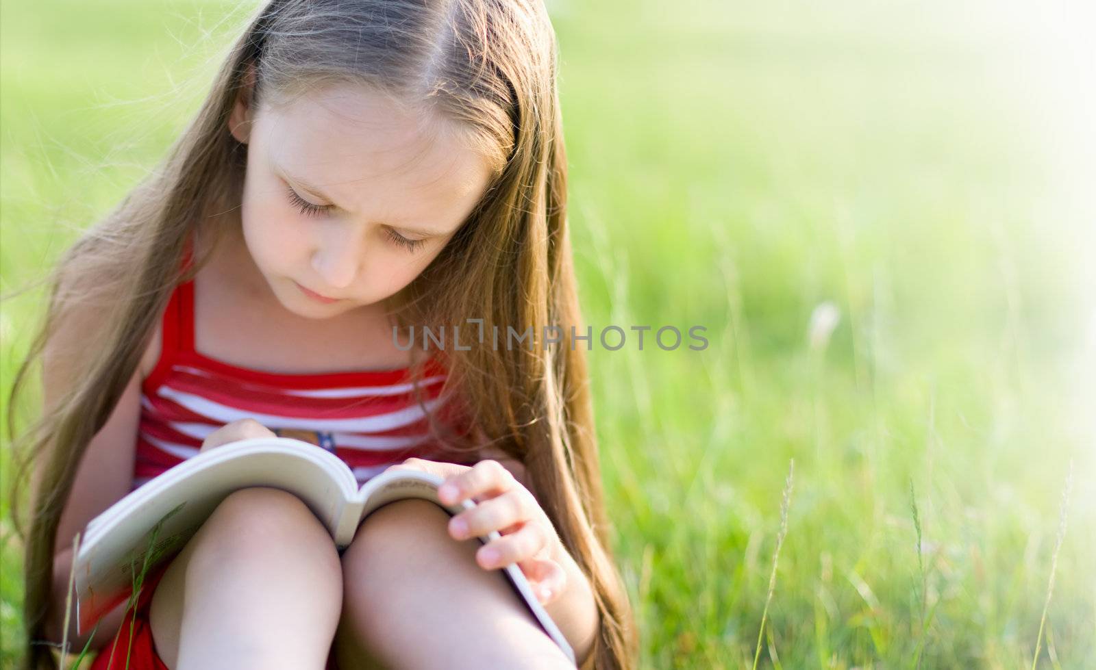 girl with long hair, reading a book