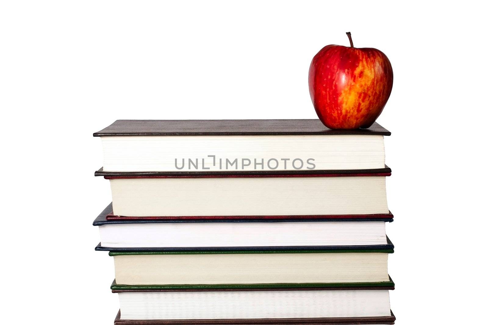 Red apple resting on top of a pile of books