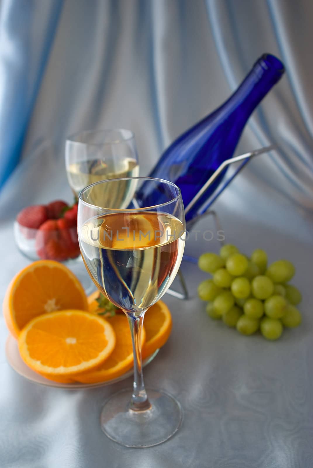 Glasses of wine with oranges and grapes