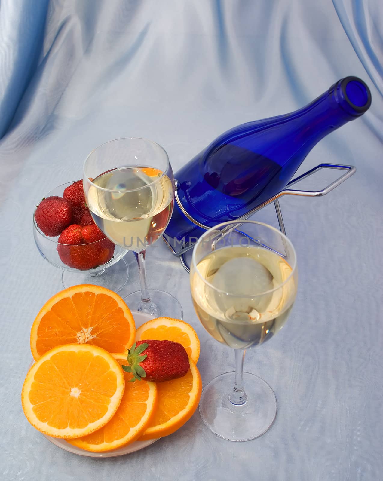Glasses of wine with oranges and strawberry